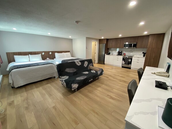 Deluxe Room, 2 Queen Beds, Kitchen (A) | Memory-foam beds, desk, blackout curtains, iron/ironing board - Western Traveller Motel (Grand Forks)