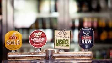 Four beer taps with labels: XXXX Gold, Carlton Draught, James Squire One Fifty Lashes Pale Ale, and Tooheys New Australian Lager.