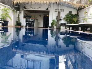 A clear pool with a thatched roof and potted plants around. - Champey Villa (Siem Reap)