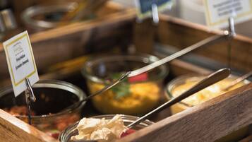 A buffet with various food options, including a sign for fresh cheese.