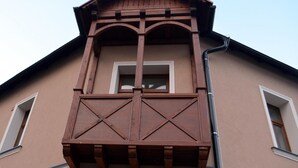 A building with a wooden balcony and a window.