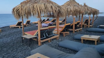 On the beach, sun loungers, beach umbrellas