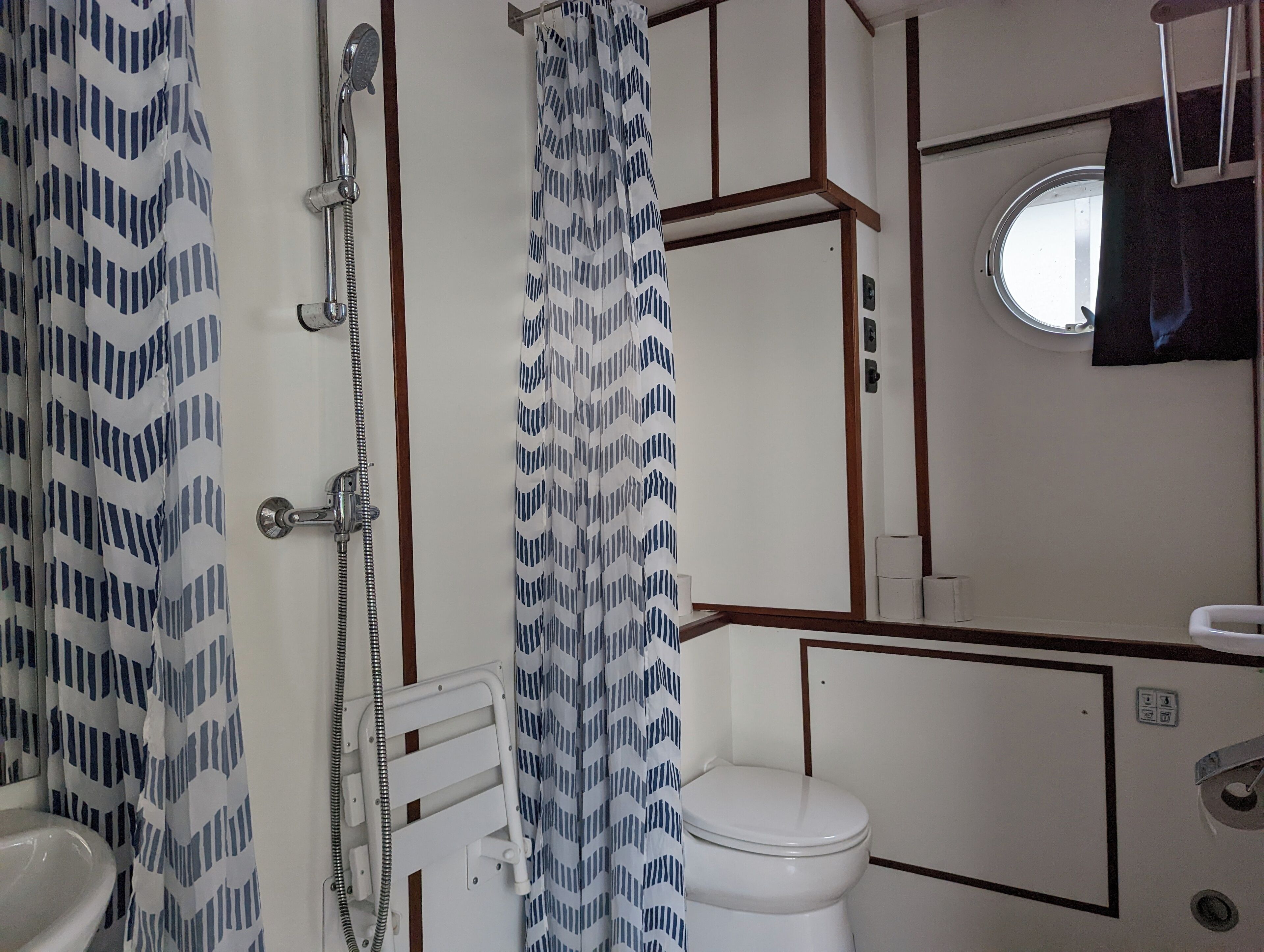 A bathroom with a shower, toilet, and sink.