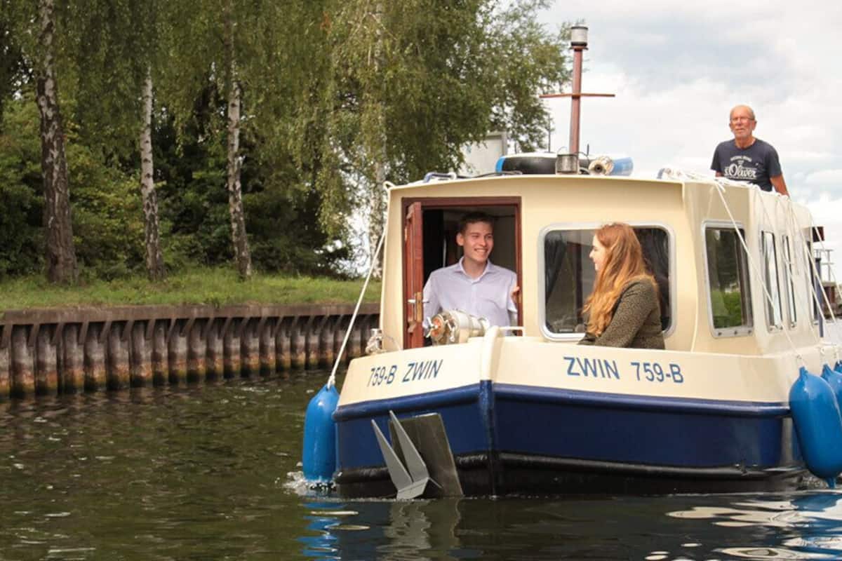 A narrowboat named 'ZWIN 759-B' on a river.