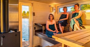A sauna room with wooden benches and a large window overlooking a body of water. - Boats & Yachts at Rechlin Harbor by Kuhnle-Tours  (Rechlin)