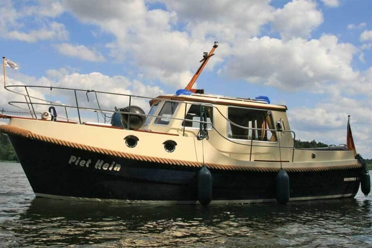 A boat named 'Piet Hein' on water.