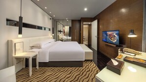 A modern hotel room with a large bed, a bedside table, a TV, and a desk with a lamp. - Metropolo Dahua Hotel Shanghai (Shanghai)