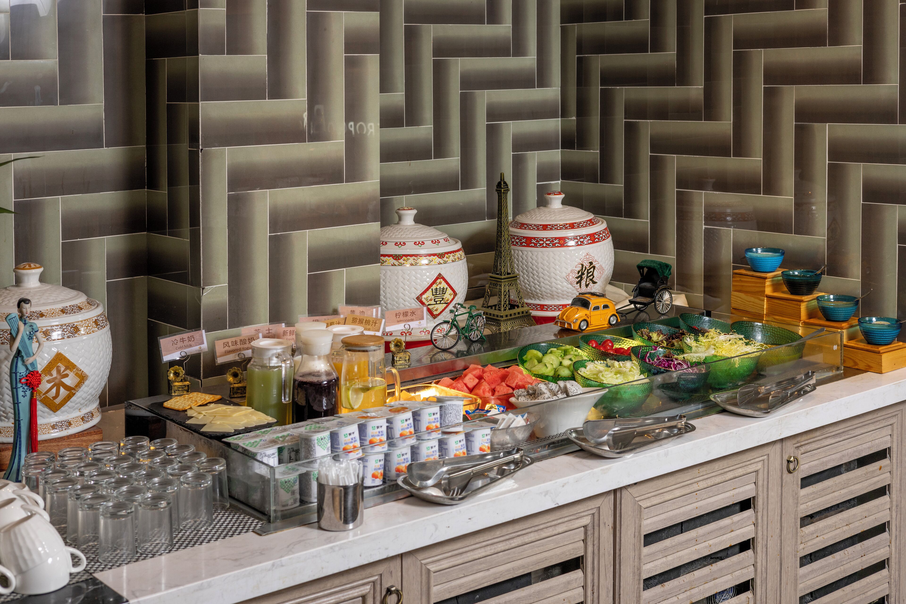 A buffet setup with various food items, condiments, and utensils.