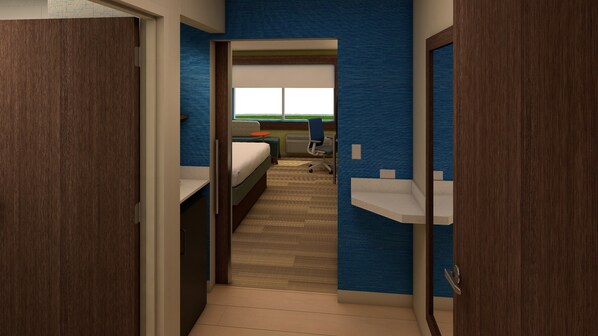 A hotel room with a bed, a desk, a chair, and a view of a green landscape through the window. - Holiday Inn Express & Suites Alabaster by IHG (Alabaster)