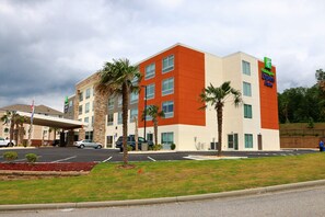 A Holiday Inn Express building with a modern design, featuring a flat roof and a mix of beige and orange colors. - Holiday Inn Express & Suites Alabaster by IHG (Alabaster)