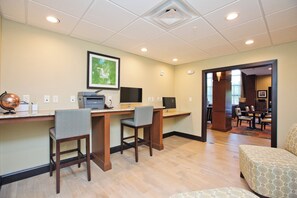 A hotel room with a desk, two chairs, a globe, a printer, and a framed picture on the wall. - Staybridge Suites Austin South Interstate Hwy 35 by IHG (Austin)