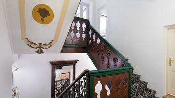 A staircase with ornate railings and a patterned carpet.