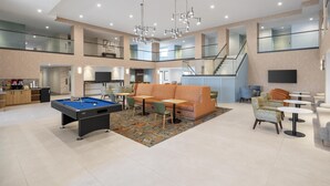 A spacious indoor area with a pool table, seating, and a staircase. - Hampton Inn & Suites by Hilton San Diego SeaWorld Near Old Town (San Diego)
