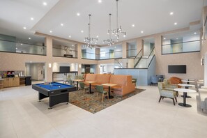 A spacious indoor area with a pool table, seating, and a staircase. - Hampton Inn & Suites by Hilton San Diego SeaWorld Near Old Town (San Diego)