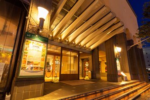A hotel entrance with a signboard, a covered walkway, and a staircase leading up. - Hotel Terrace The Square Hitachi (Hitachi)