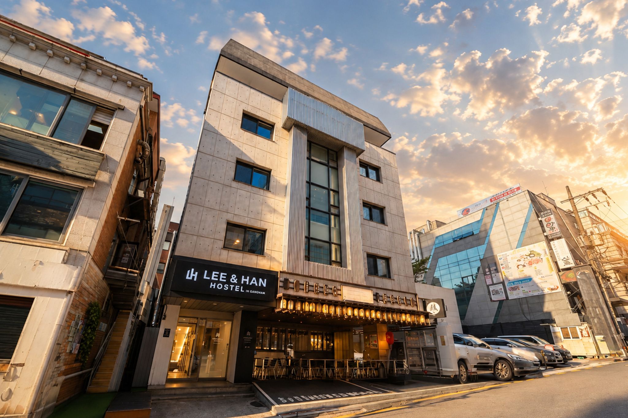 A modern building with a restaurant named 'LEE & HAN HOSTEL INNANCHAM' on the ground floor.