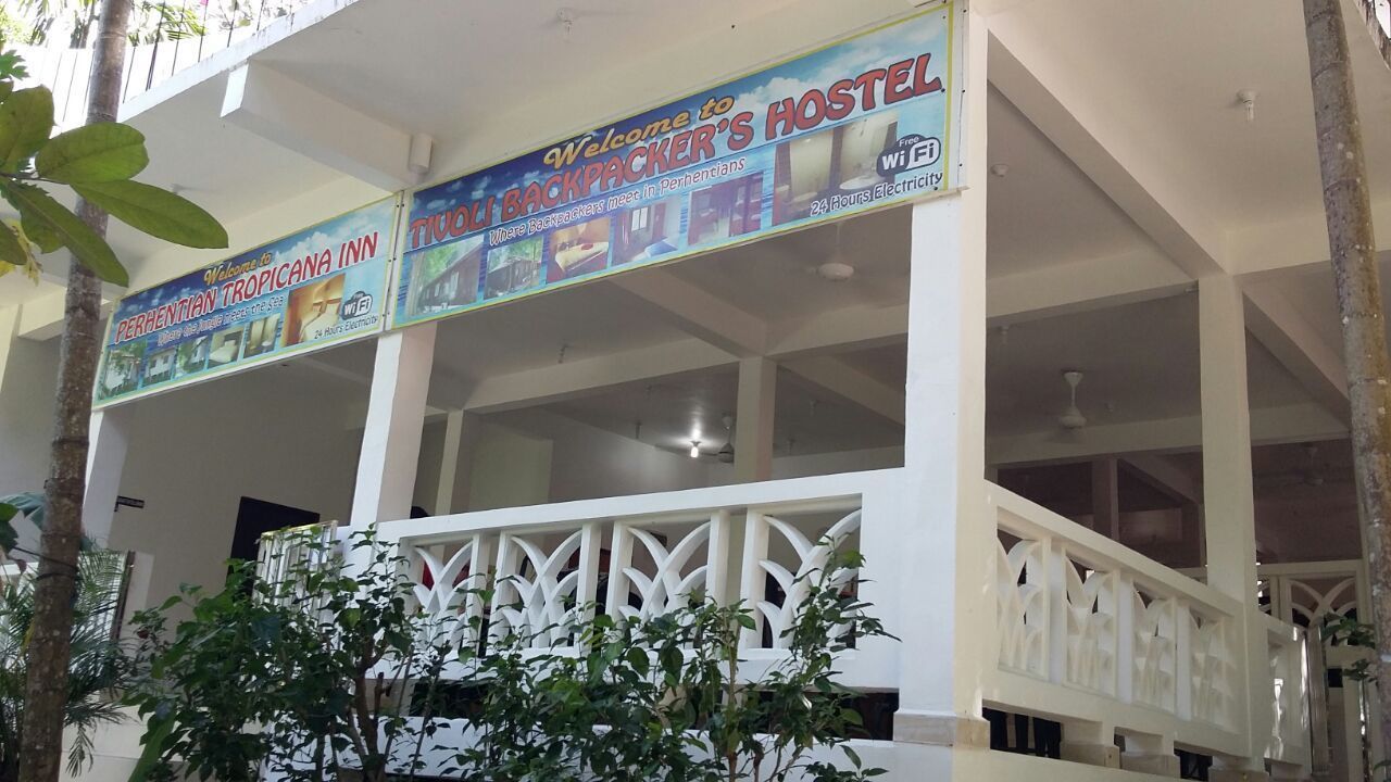 A hostel with a signboard advertising 24-hour electricity and wi-fi.