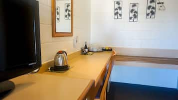 Minibar, desk, laptop workspace, iron/ironing board
