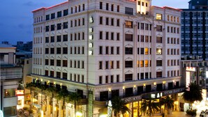 A multi-story hotel with a classic architectural style, featuring a prominent entrance with a canopy and a well-lit facade. - Justwin Grand Hotel (Tainan)