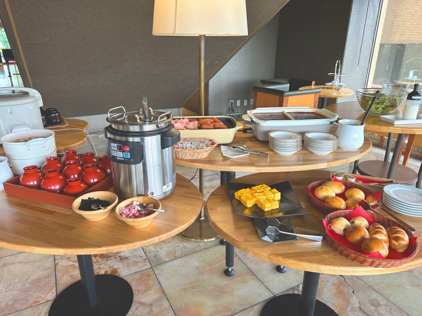 A breakfast buffet with various food items and cooking equipment.