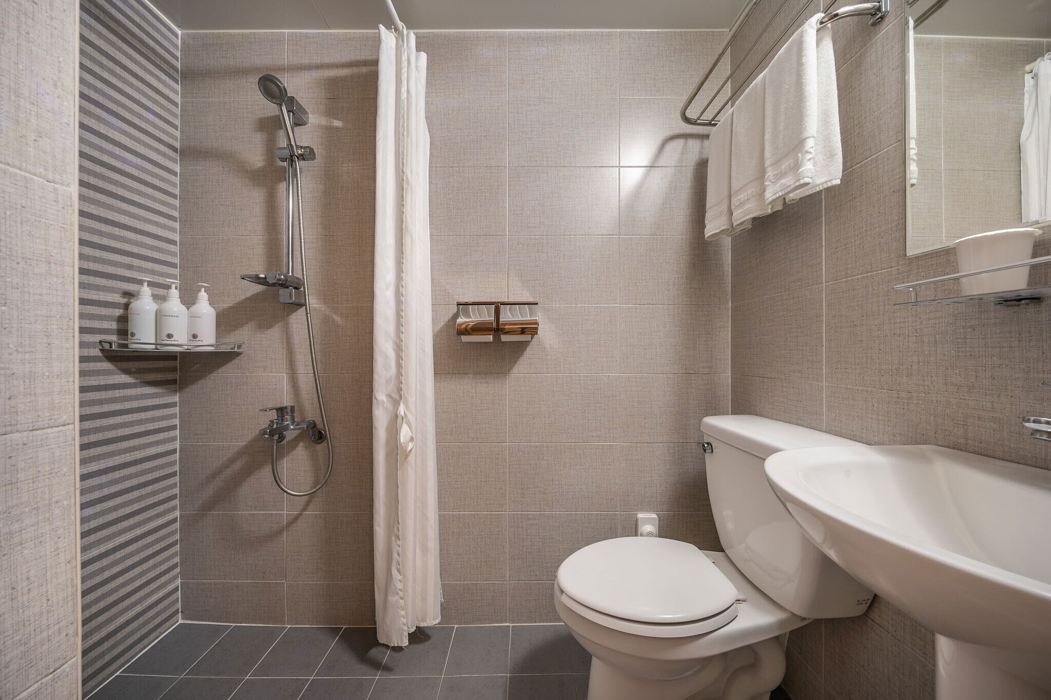 standard twin room | bathroom | shower, hair dryer, towels, soap