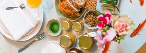 Enjoy a beautifully set breakfast table with a delicious spread and fresh flowers.