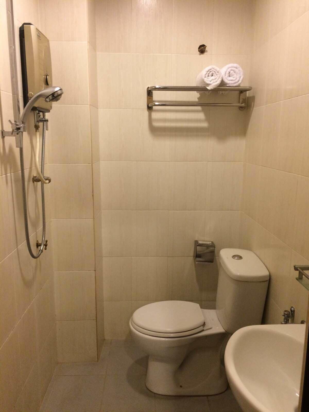 A small, compact bathroom with a toilet, bidet, and sink.