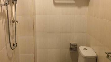 A small, compact bathroom with a toilet, bidet, and sink.