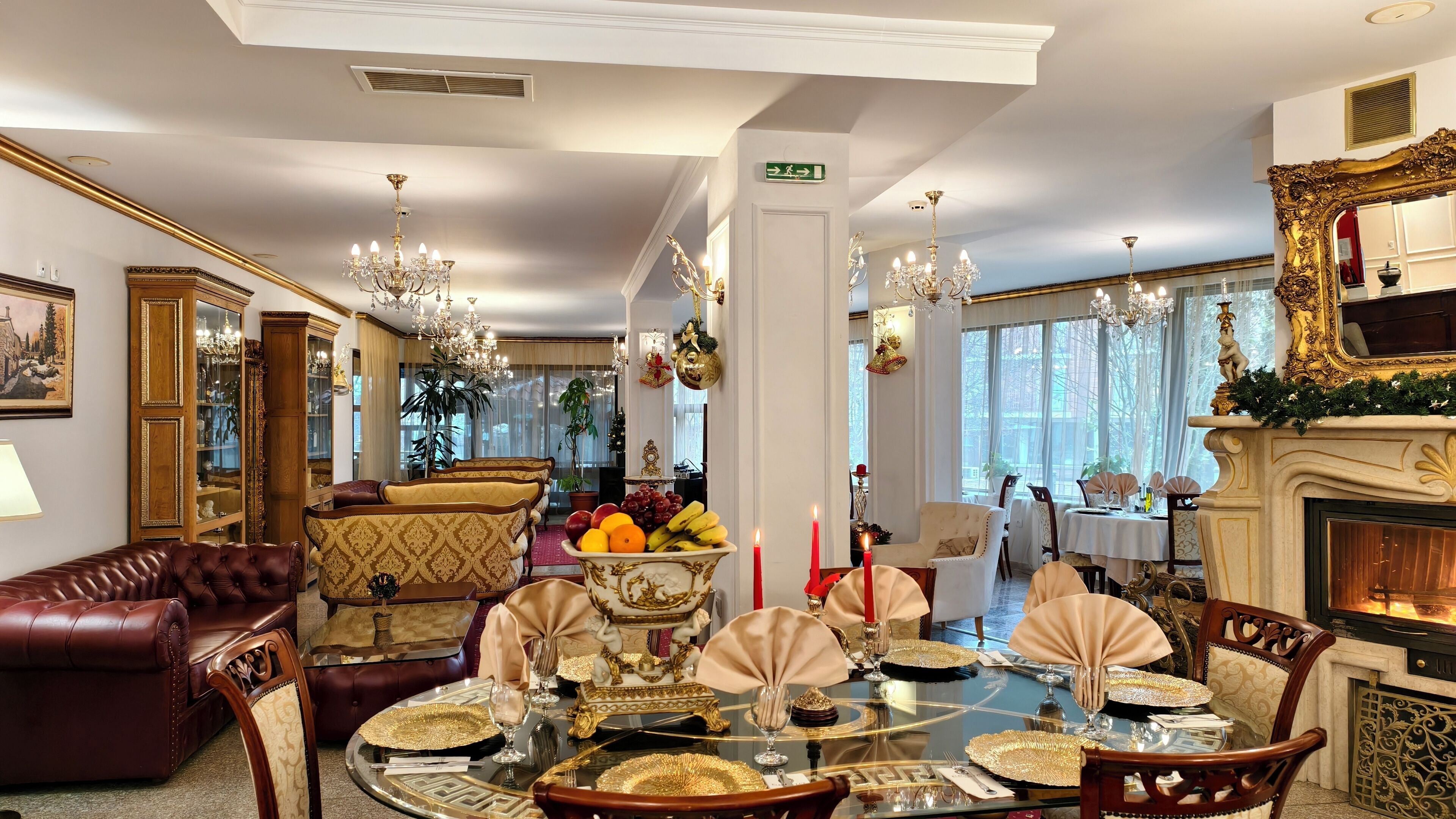 A luxurious dining room with a round table set for a meal, surrounded by elegant chairs.