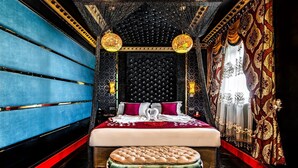 A luxurious bedroom with a large bed, ornate curtains, and a decorative ceiling. - Grand Sapphire Hotel & Banqueting (Croydon)