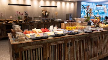A buffet with various food items and beverages.