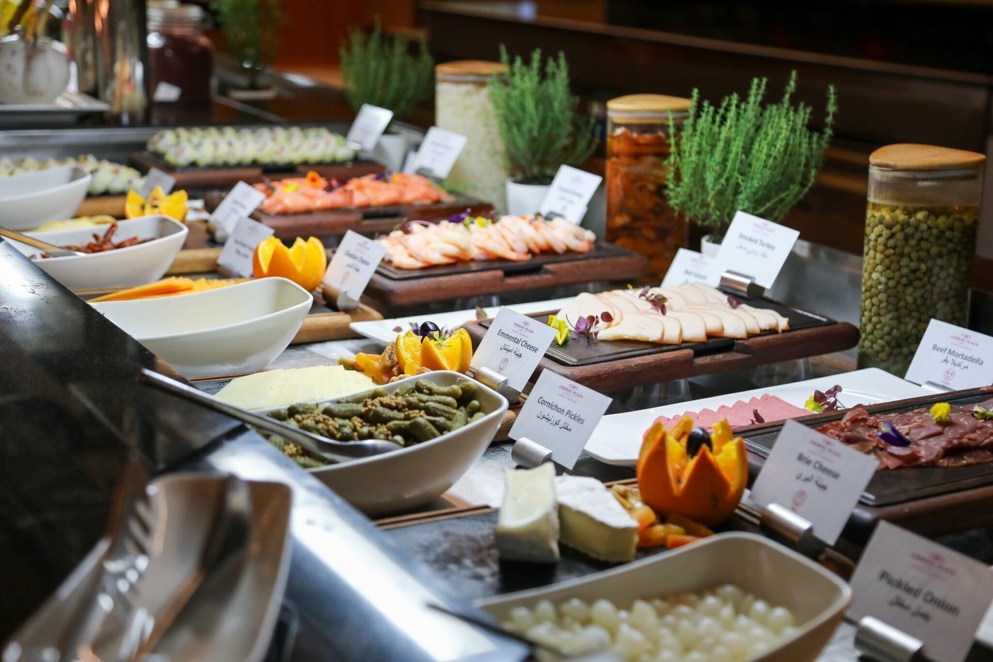 A buffet with various food items and labels.