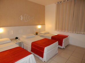 A hotel room with two beds, a wall-mounted fish decoration, and a window with curtains. - Perolas Do Mar Pousada (Maceio)