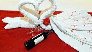A bed with white linens, a red blanket, and a bottle of wine. - Perolas Do Mar Pousada (Maceio)