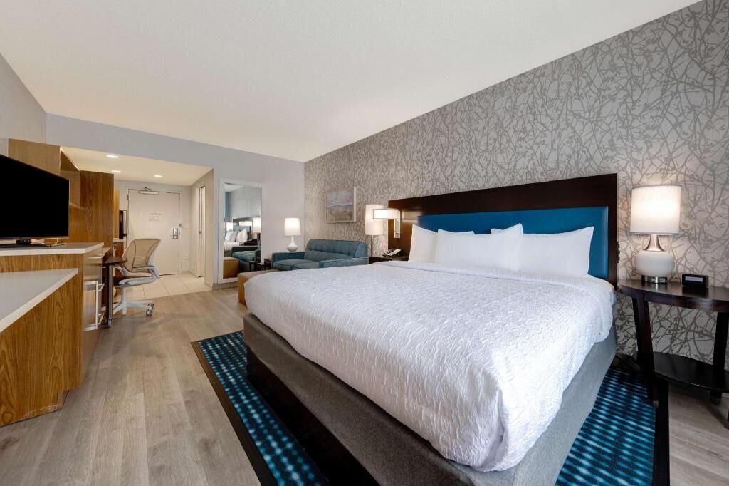 Premium bedding, desk, laptop workspace, blackout drapes