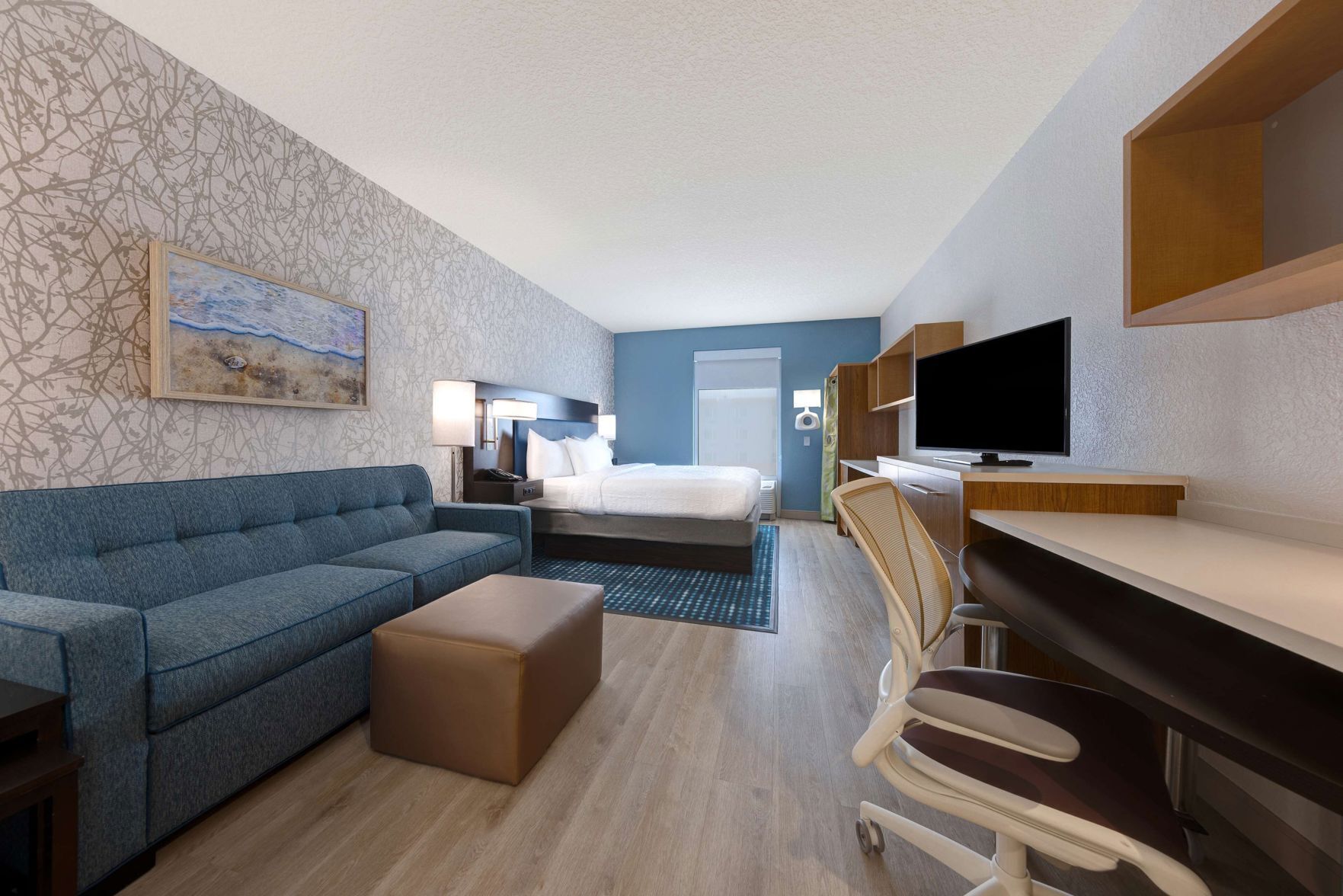 Premium bedding, desk, laptop workspace, blackout drapes