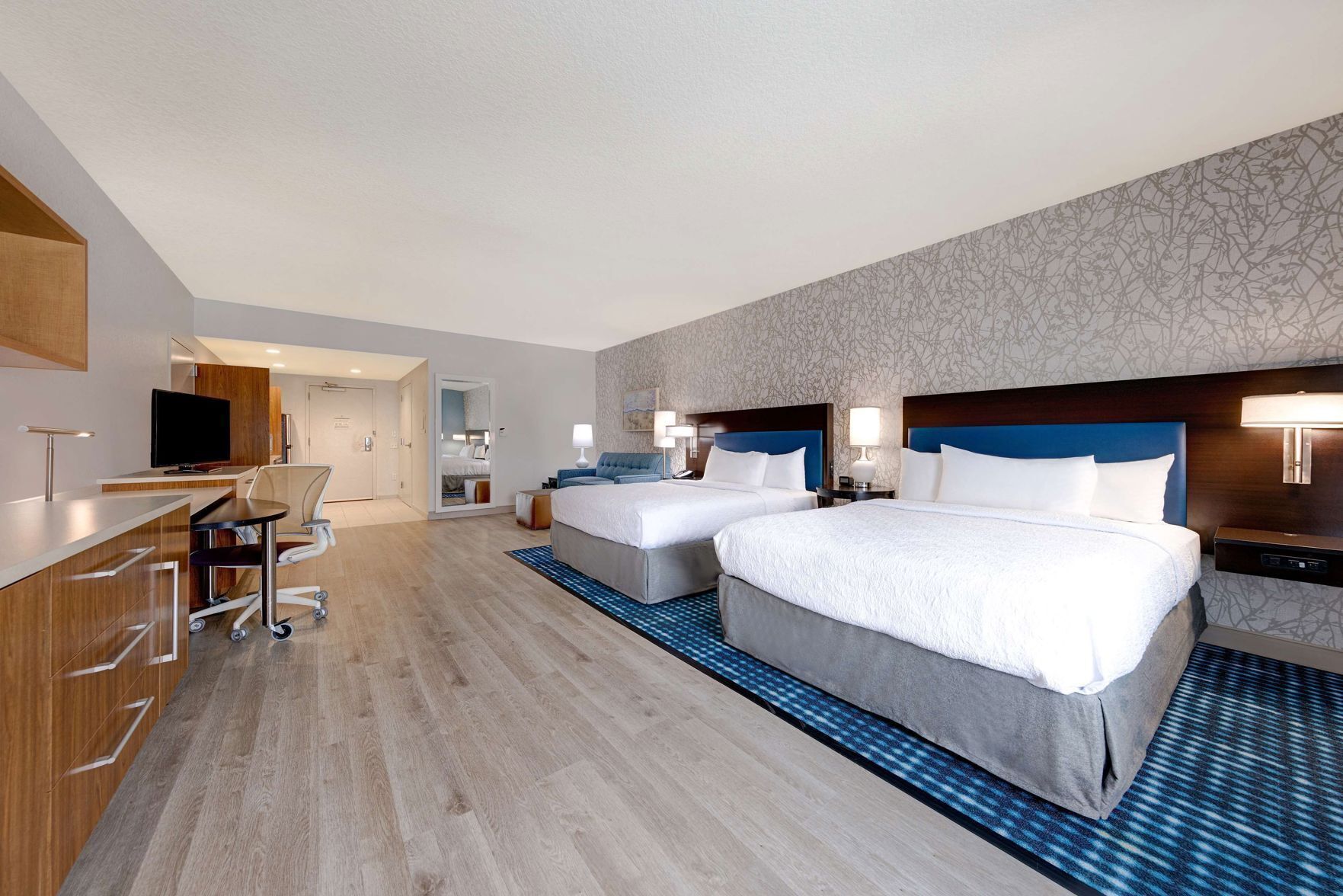 Premium bedding, desk, laptop workspace, blackout drapes