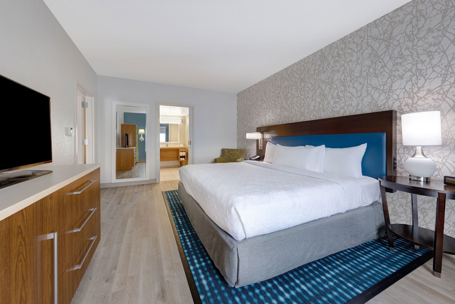 Premium bedding, desk, laptop workspace, blackout drapes