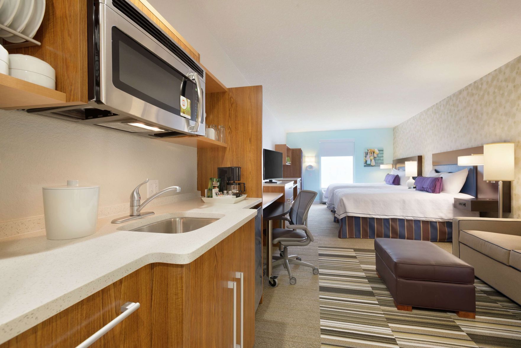 Premium bedding, desk, laptop workspace, blackout drapes