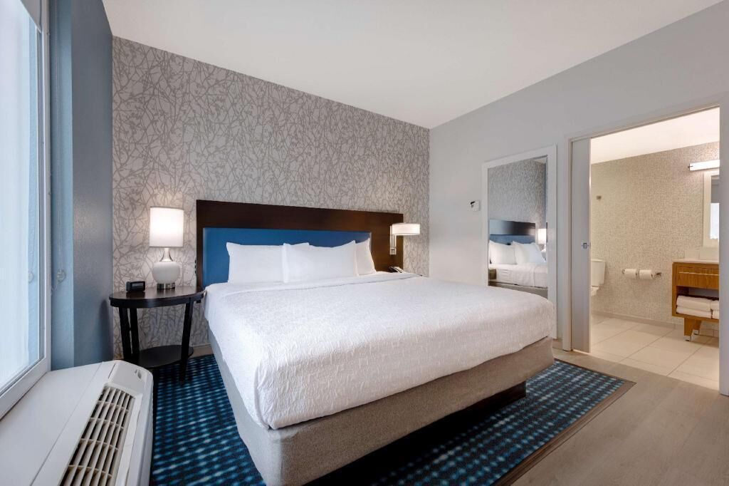 Premium bedding, desk, laptop workspace, blackout drapes
