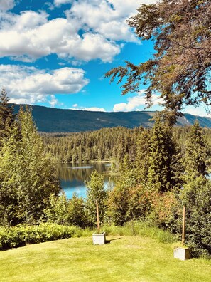 A lake surrounded by dense forest and mountains under a clear sky. - Hotel Civilia Lakeside by Civilia Golf Retreat (Clearwater)