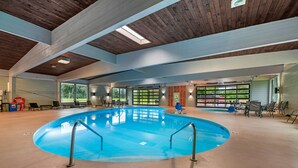 An indoor swimming pool with a wooden ceiling and large windows. - Fairway Inn and Suites, an Ascend Collection Hotel (Mishicot)