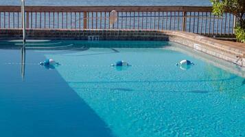 Outdoor pool, a heated pool, open 8:00 AM to 7:00 PM, pool loungers