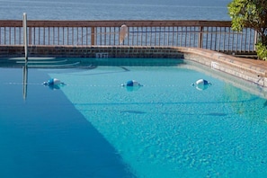 Outdoor pool, a heated pool, open 8:00 AM to 7:00 PM, pool loungers