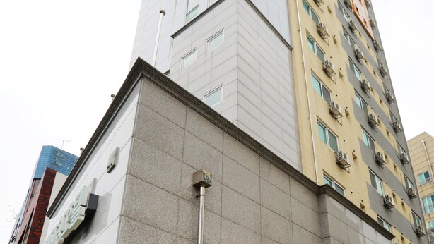 A multi-story building with a mix of residential and commercial spaces.