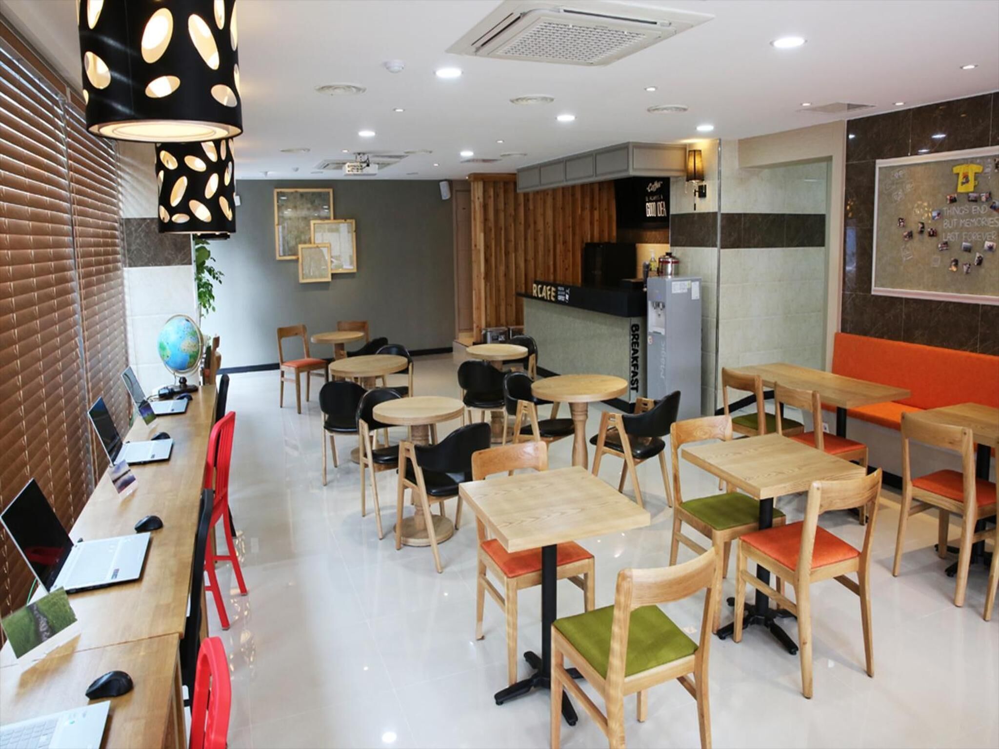A cafe with round tables, chairs, and a counter.