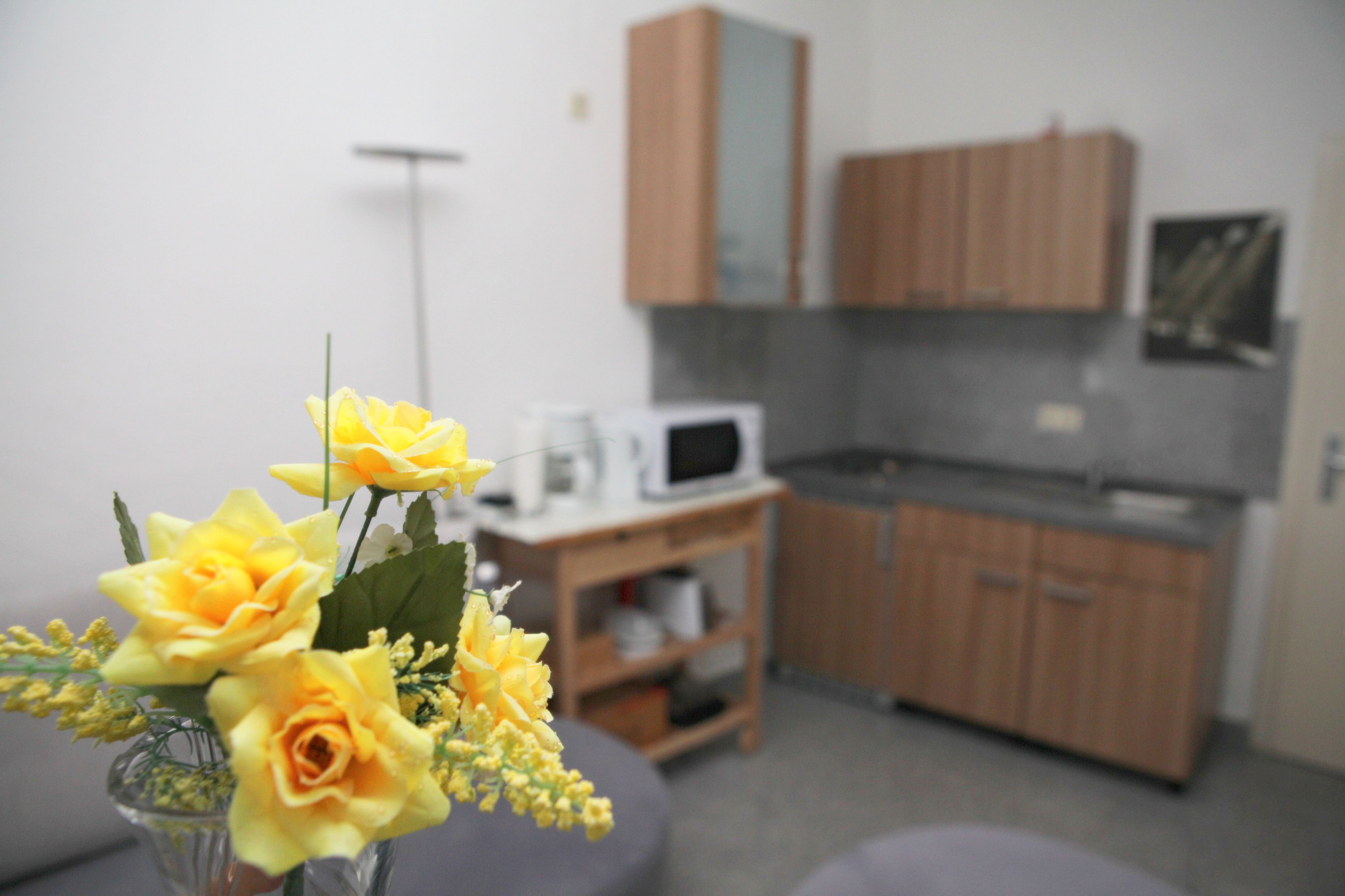 A small kitchenette with wooden cabinets and a microwave.