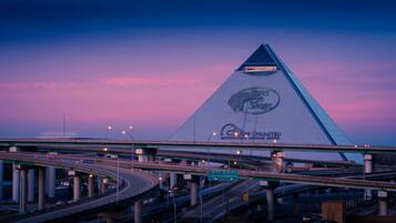 A highway interchange with multiple overpasses and a large building with a distinctive triangular roof and signage for 'Bass Pro Shops' and 'Waterpower Heritage Center'.