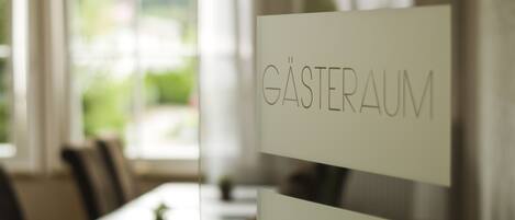 A restaurant interior with a sign reading "GÄSTERAUM" indicating a guest room.
