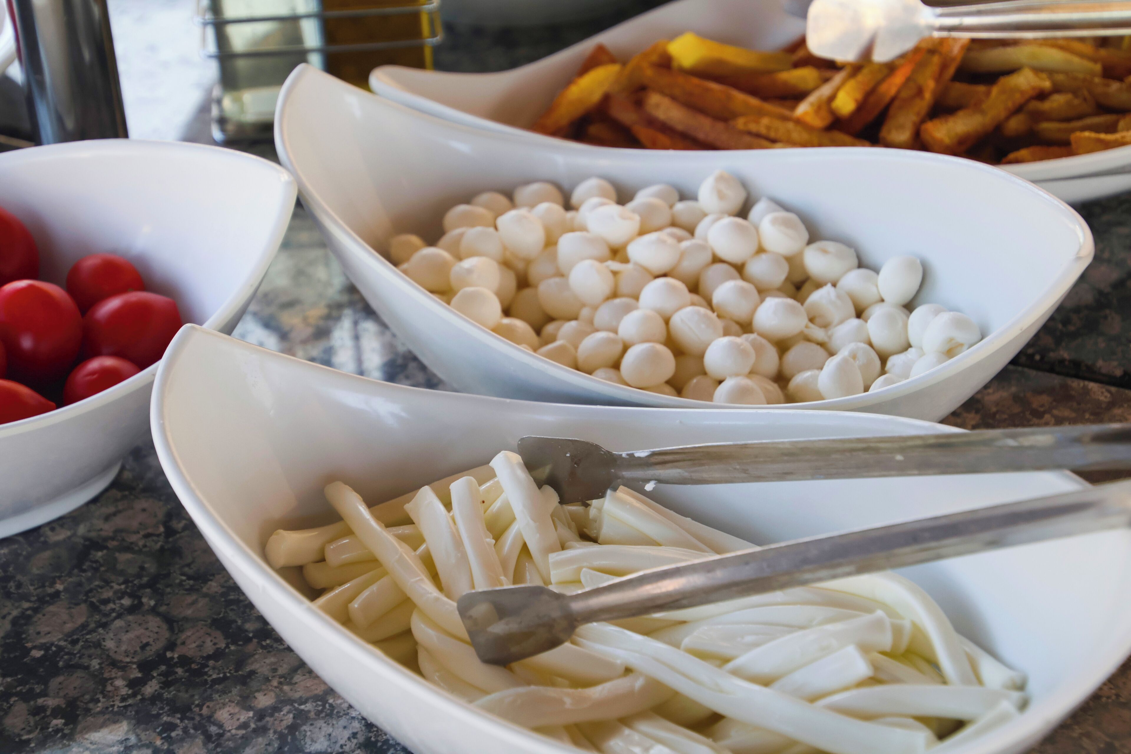 Bowls of food items on a table.